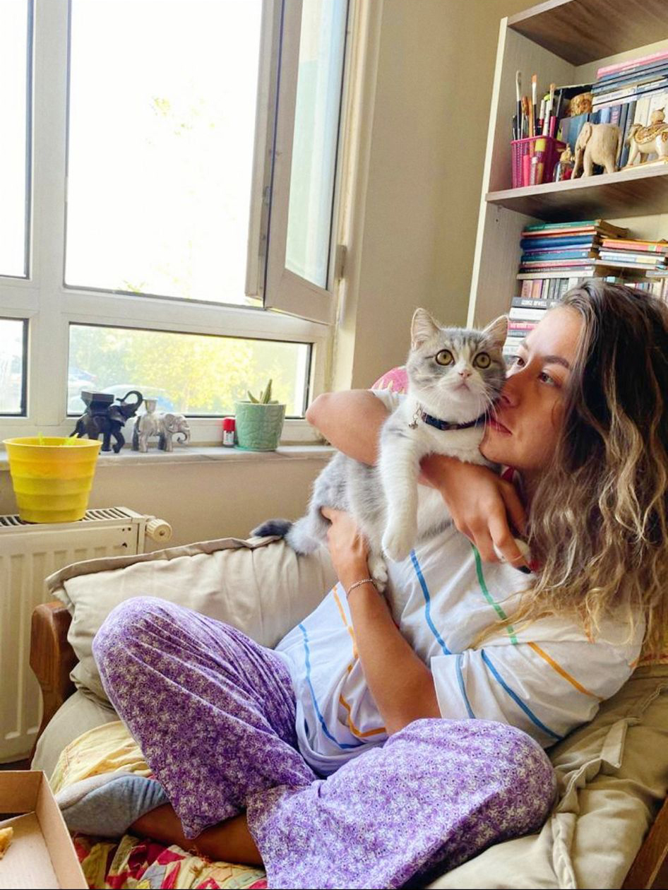 Nida with cat by the window